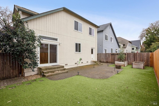 rear view of property featuring a lawn and a patio