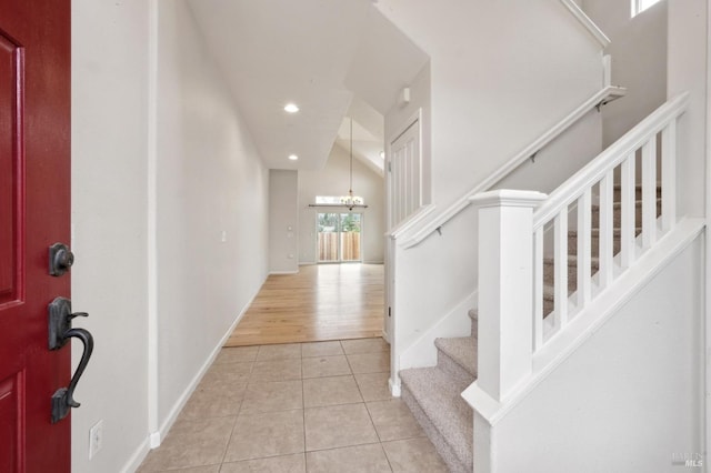 tiled entrance foyer featuring a chandelier