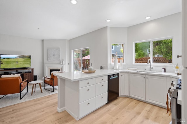 kitchen featuring sink, white cabinets, dishwasher, and light wood-type flooring