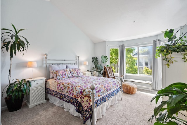 bedroom with light carpet and vaulted ceiling