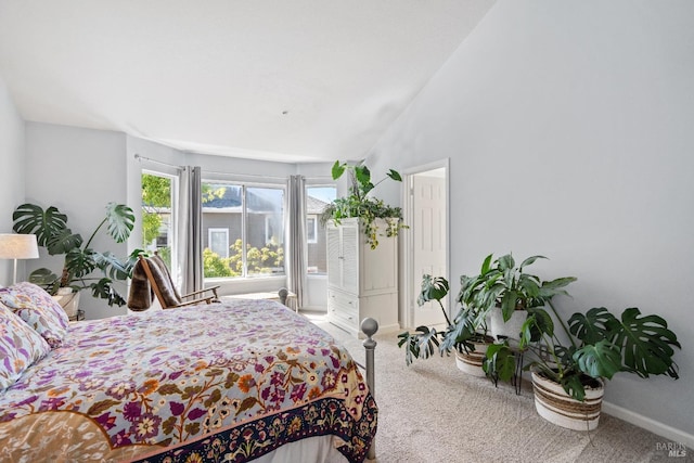 bedroom with carpet flooring and vaulted ceiling