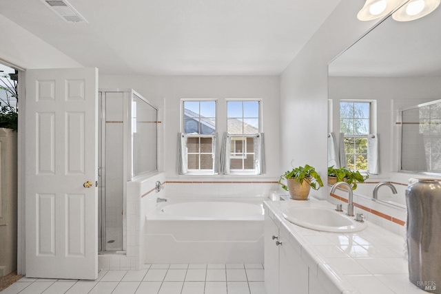 bathroom featuring tile patterned floors, separate shower and tub, and vanity