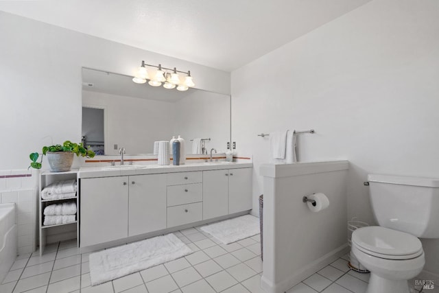 bathroom featuring a tub to relax in, tile patterned floors, vanity, and toilet