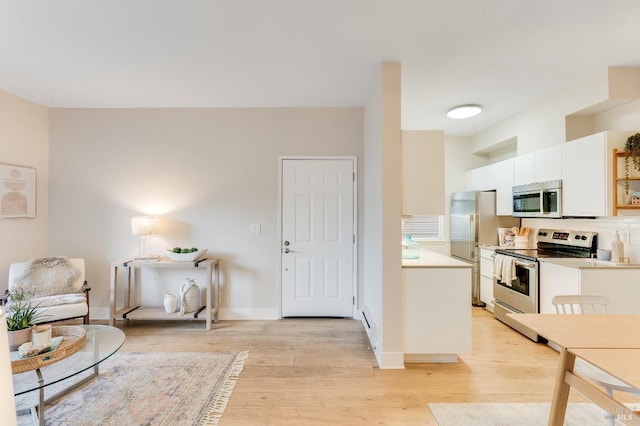 57 Lakeshore Ct, Richmond, CA 94804 - kitchen featuring white cabinets, light countertops, light wood-type flooring, and stainless steel appliances