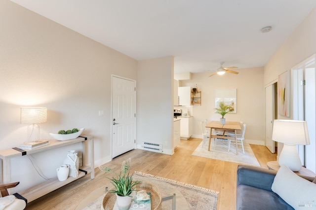 57 Lakeshore Ct, Richmond, CA 94804 - living room featuring a baseboard heating unit, light wood-type flooring, a ceiling fan, and baseboards
