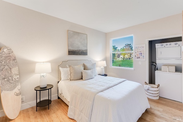 57 Lakeshore Ct, Richmond, CA 94804 - bedroom with wood finished floors and stacked washer and clothes dryer