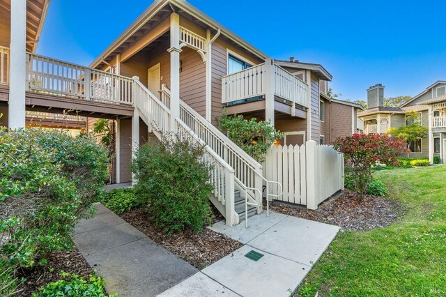 57 Lakeshore Ct, Richmond, CA 94804 - view of home's exterior featuring stairway and a yard