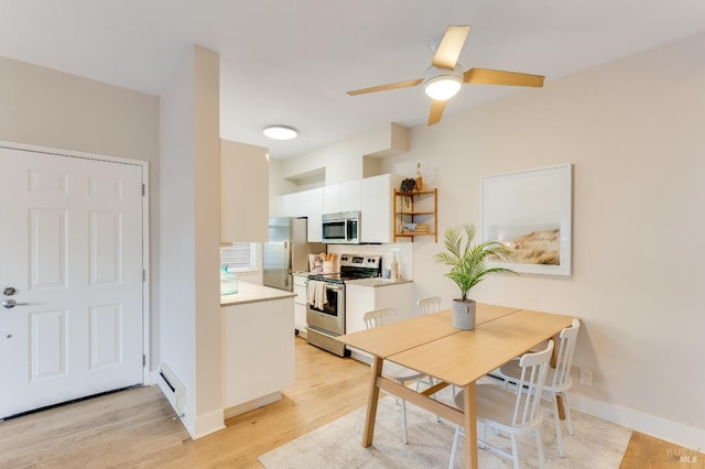 57 Lakeshore Ct, Richmond, CA 94804 - dining room featuring baseboard heating, baseboards, light wood-style floors, and ceiling fan