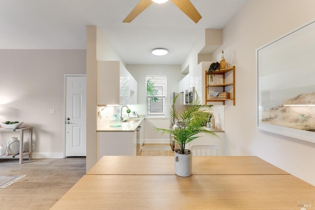 57 Lakeshore Ct, Richmond, CA 94804 - dining space with light wood-type flooring, baseboards, and ceiling fan