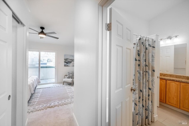 bathroom with vanity, ceiling fan, and walk in shower