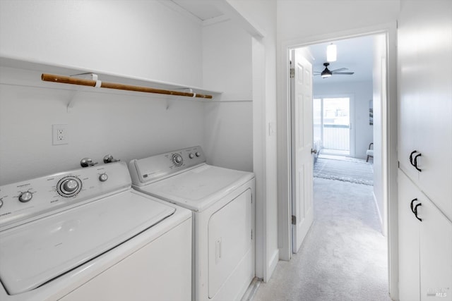 laundry area featuring washer and dryer, ceiling fan, and light carpet