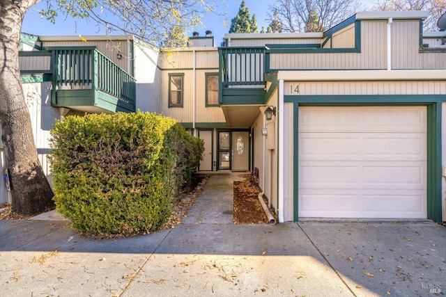 multi unit property featuring a garage and a balcony