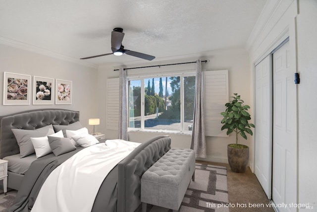 bedroom featuring crown molding, a closet, ceiling fan, and carpet flooring