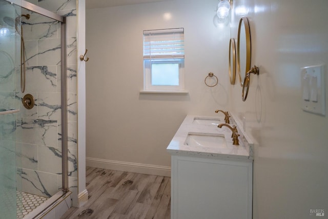 bathroom with vanity, hardwood / wood-style flooring, and a shower with shower door