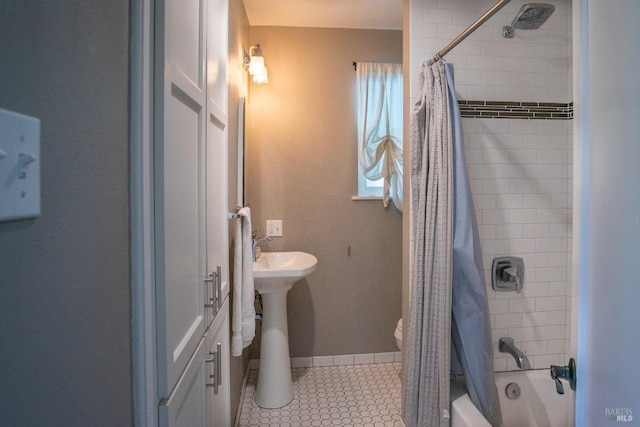 bathroom with tile patterned flooring, shower / bath combination with curtain, and toilet