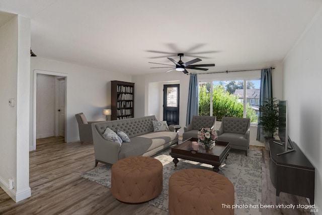 living room featuring wood-type flooring, plenty of natural light, and ceiling fan