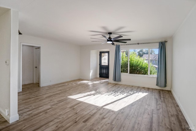 spare room with ceiling fan, plenty of natural light, and light hardwood / wood-style floors