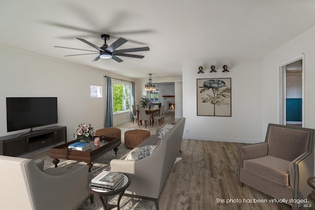 living room with wood-type flooring and ceiling fan