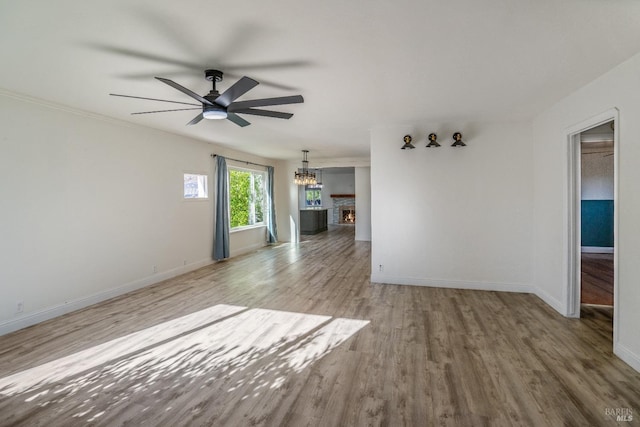 unfurnished living room featuring wood-type flooring and ceiling fan