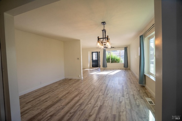 interior space with a notable chandelier and light wood-type flooring