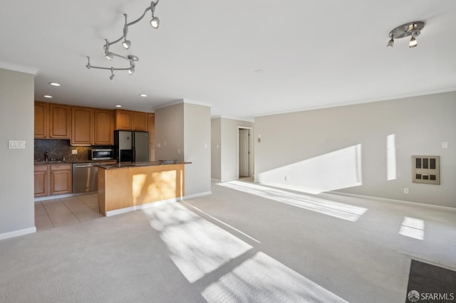 kitchen featuring backsplash, ornamental molding, light colored carpet, and appliances with stainless steel finishes