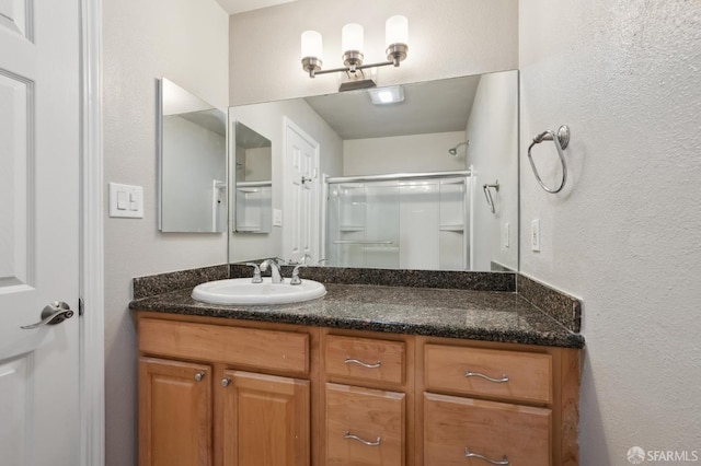 bathroom featuring vanity and an enclosed shower