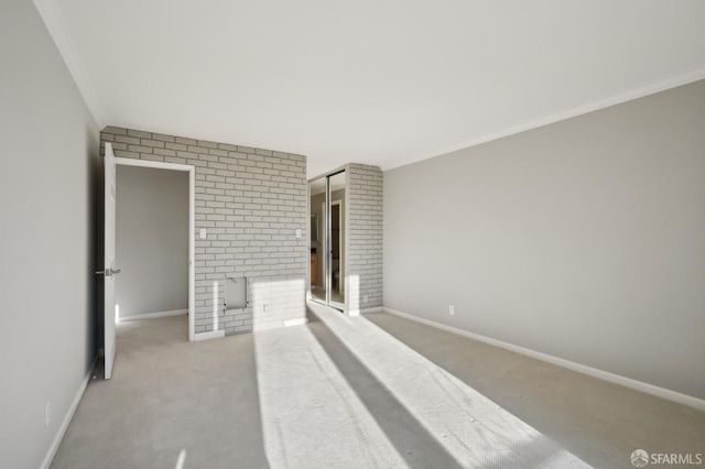 carpeted spare room featuring ornamental molding