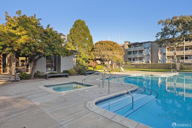 view of pool featuring a patio area and an in ground hot tub