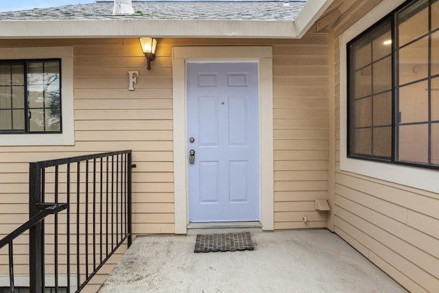 property entrance with roof with shingles