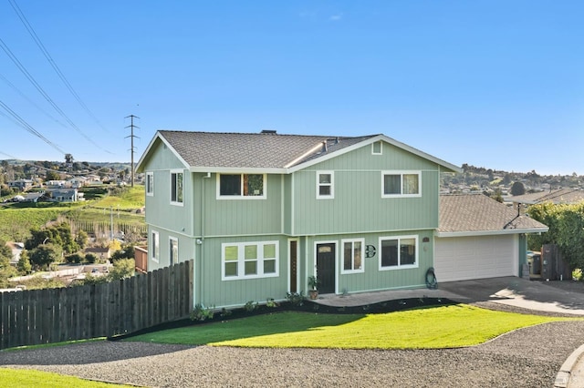 front facade featuring a garage and a front yard