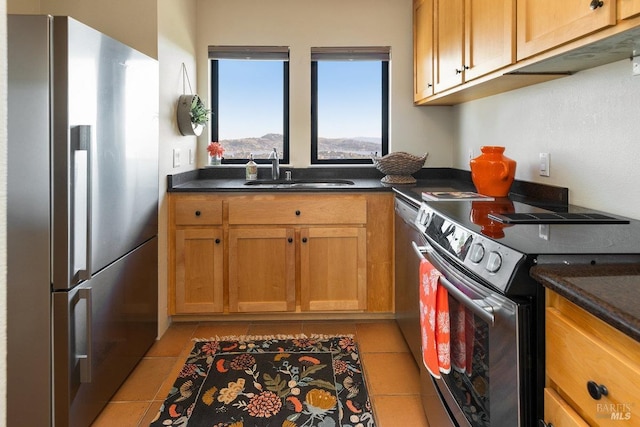 kitchen featuring stainless steel appliances, sink, and light tile patterned floors