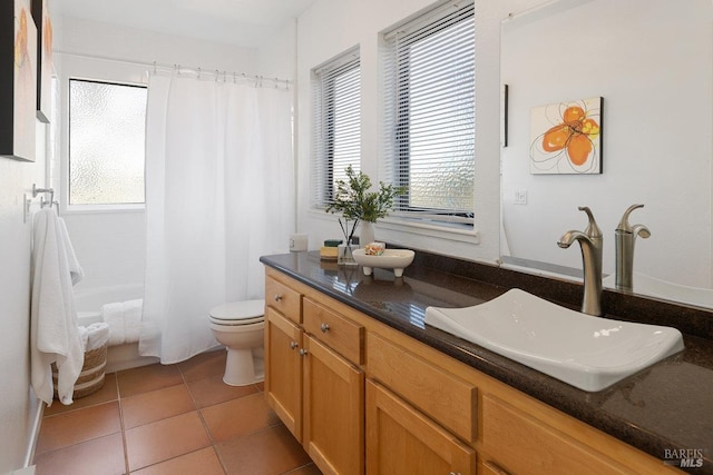 full bathroom with tile patterned floors, plenty of natural light, toilet, and vanity