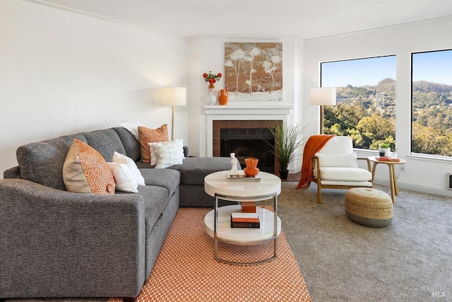 carpeted living room with a tiled fireplace