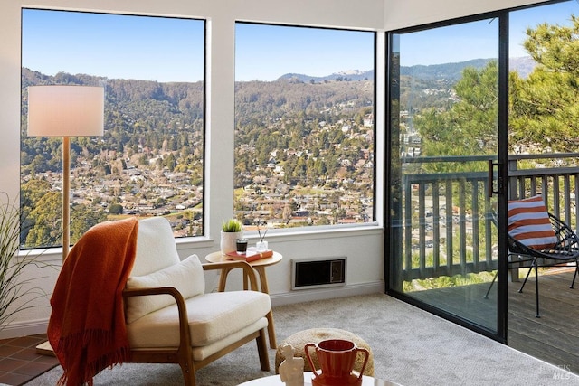 sunroom / solarium with a mountain view and a wealth of natural light