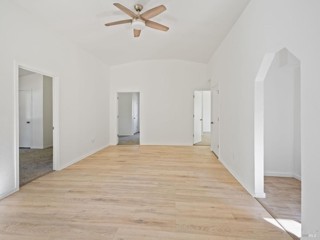 unfurnished room featuring ceiling fan, vaulted ceiling, and light wood-type flooring