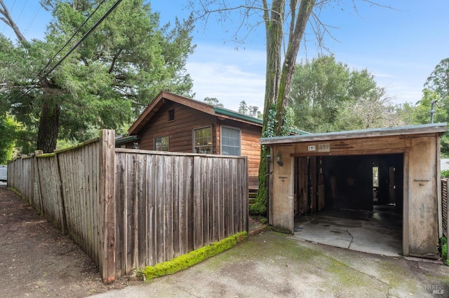 view of property exterior with an outbuilding and a garage