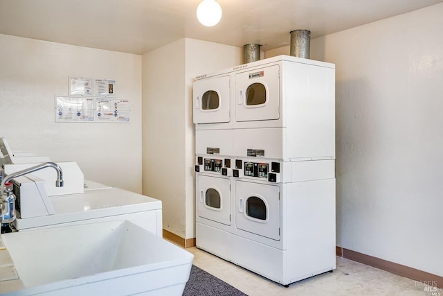 laundry room with stacked washer / drying machine and washer and dryer