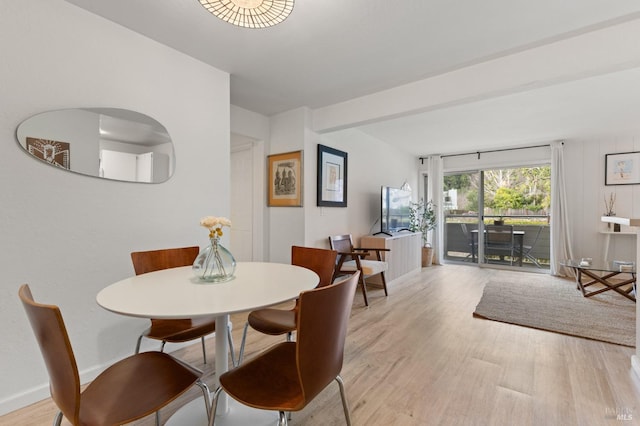 dining space with light hardwood / wood-style floors