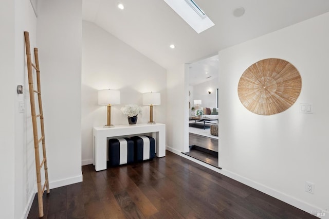 hall with dark hardwood / wood-style flooring and lofted ceiling with skylight