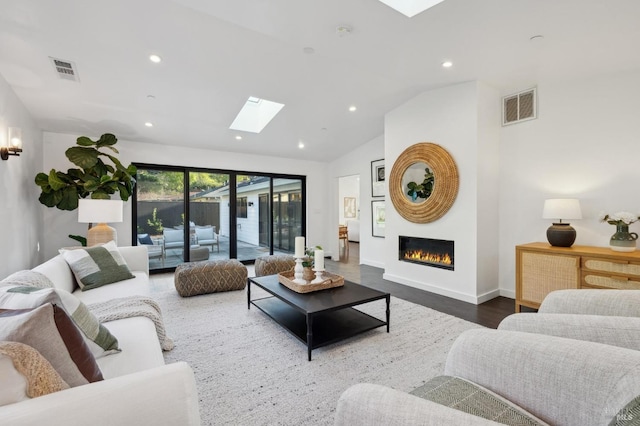 living room featuring dark wood-type flooring and lofted ceiling with skylight