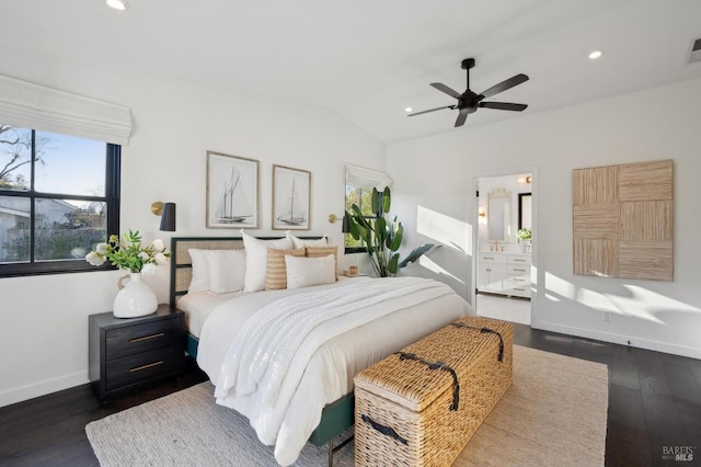 bedroom with ceiling fan, ensuite bathroom, dark hardwood / wood-style floors, and vaulted ceiling