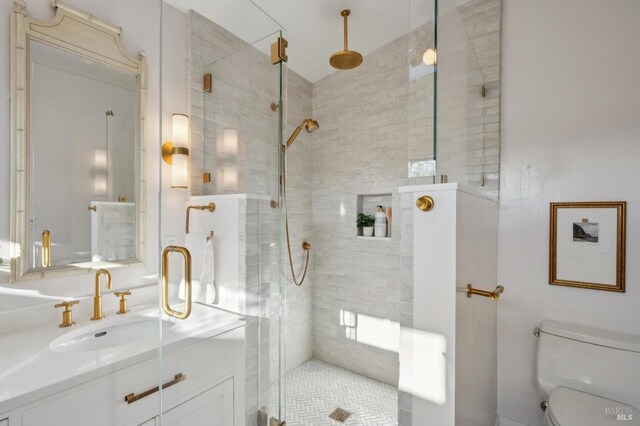 bathroom featuring walk in shower, sink, and toilet