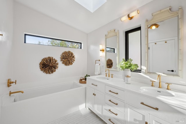 bathroom featuring vanity, lofted ceiling with skylight, tile patterned floors, and a tub to relax in