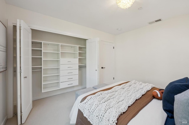 bedroom featuring light colored carpet and a closet