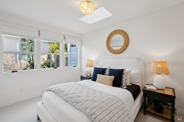 bedroom featuring carpet flooring and a skylight