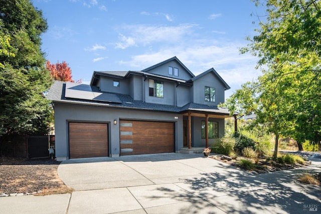 view of front of house featuring solar panels and a garage