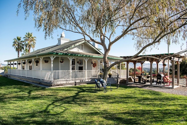 view of community with a patio area, a lawn, and a pergola