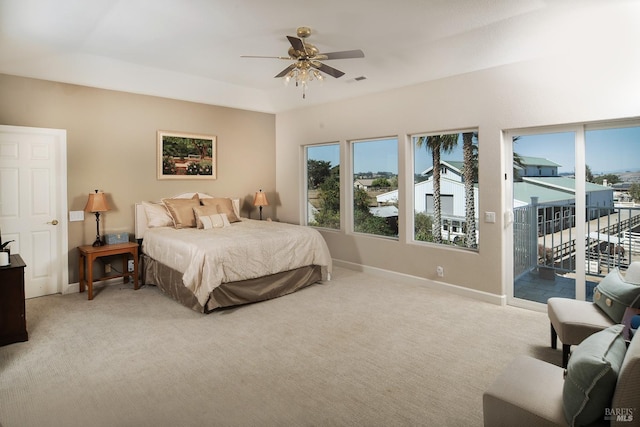 bedroom featuring a ceiling fan, access to outside, light colored carpet, and baseboards