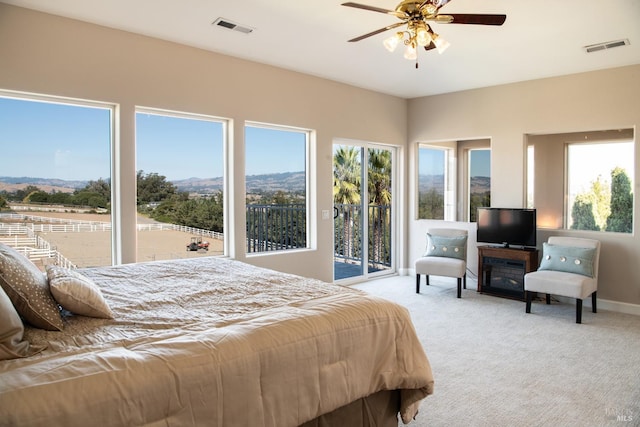 bedroom featuring visible vents, carpet floors, baseboards, and access to exterior