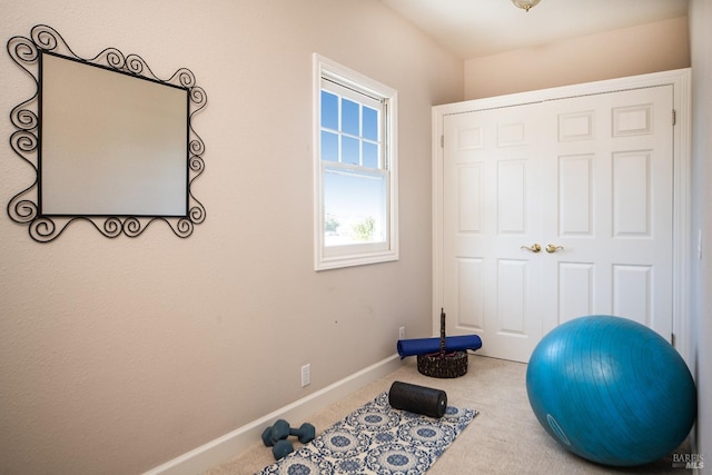 workout area with carpet flooring and baseboards